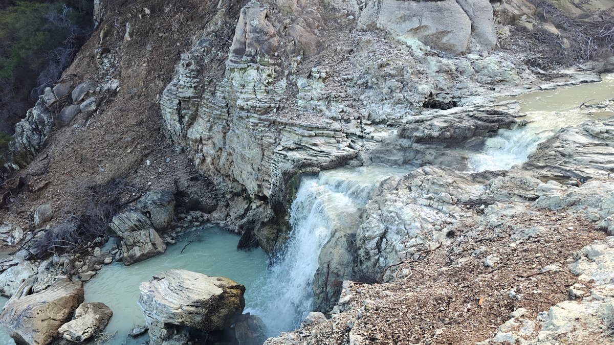 Waterfall dropping over pale rock