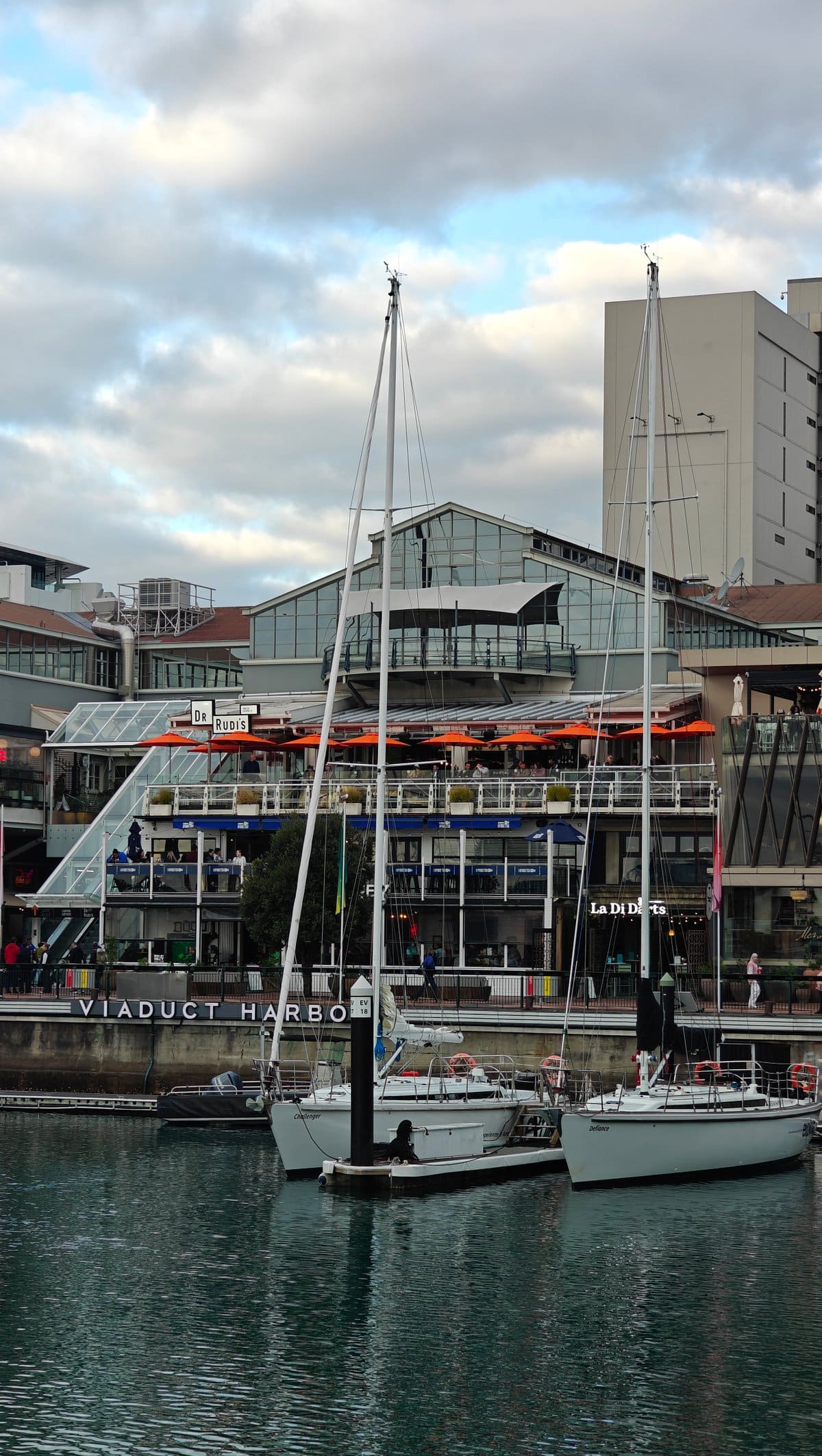 Yacht berthed against waterfront buildings