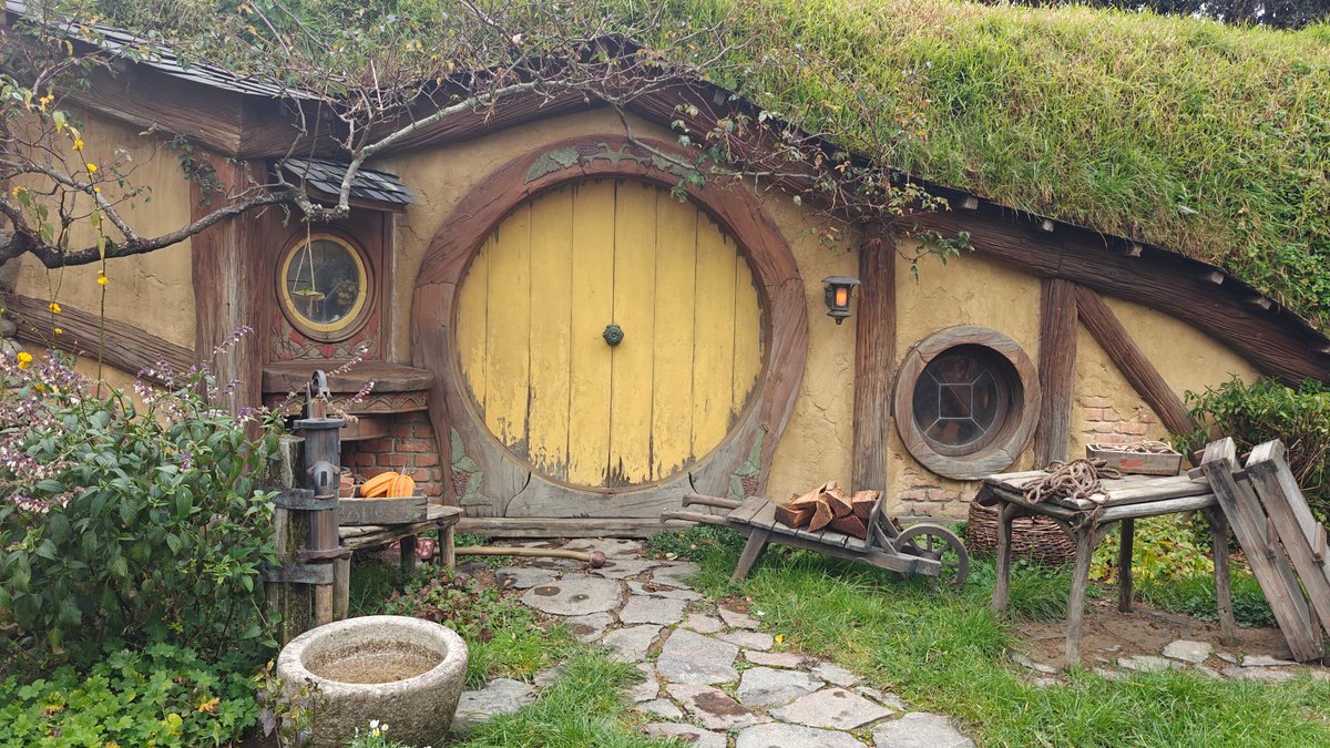 Yellow door beside a stone well